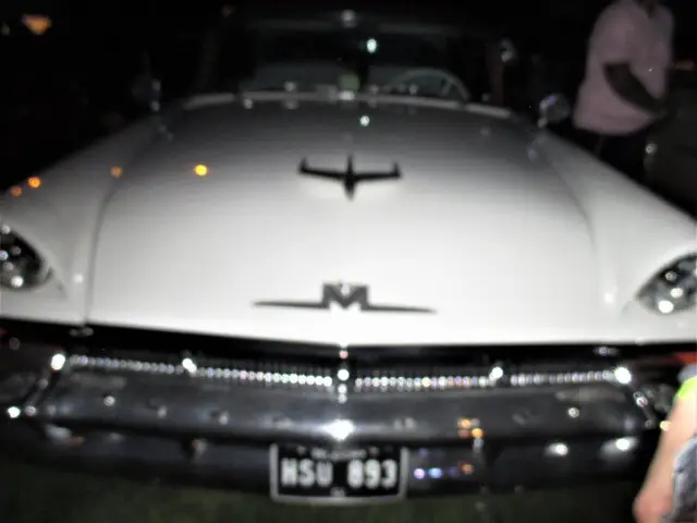 A chrome bonnet and grille at night