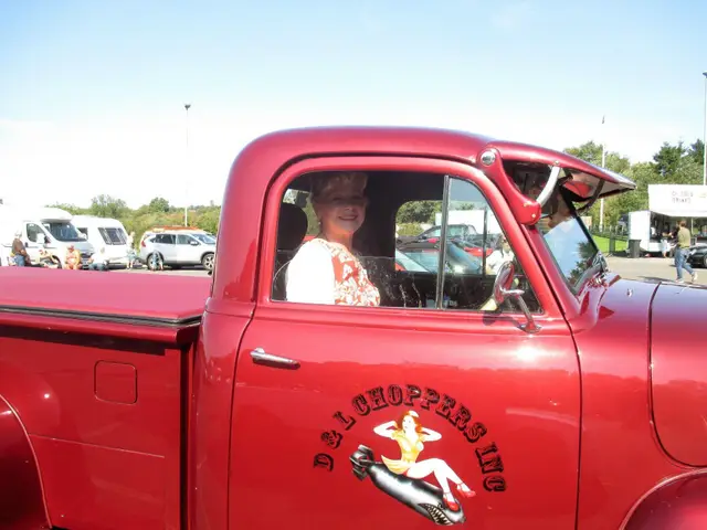 A red vintage pick-up truck at the rally